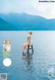 A woman sitting on a stool in the middle of a lake.